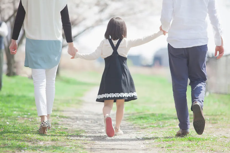 A family walking together along a sunny path