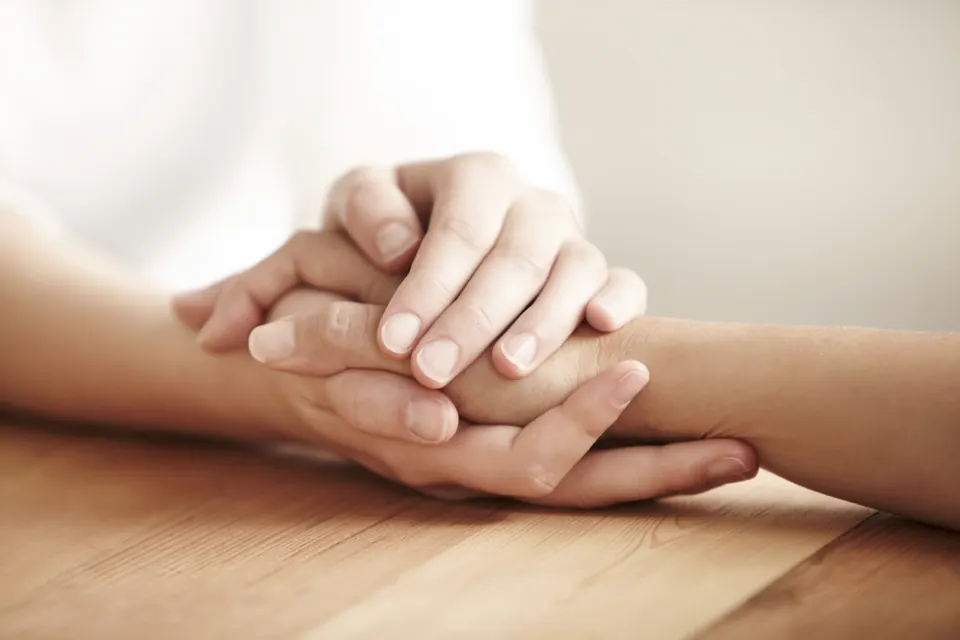 Hands clasped together in support