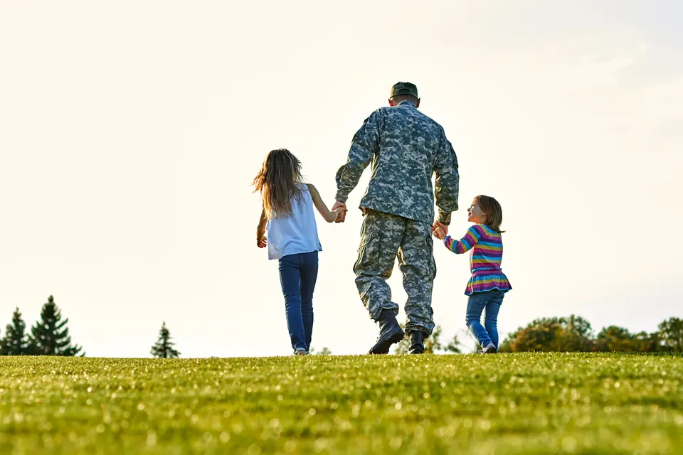 A veteran walking hand in hand with family
