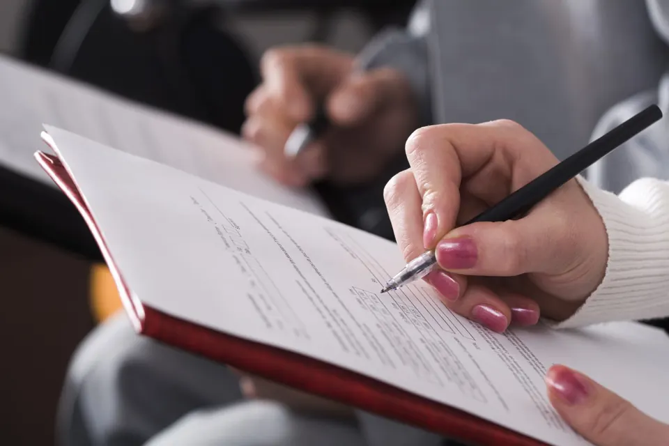 A person writing in a notebook